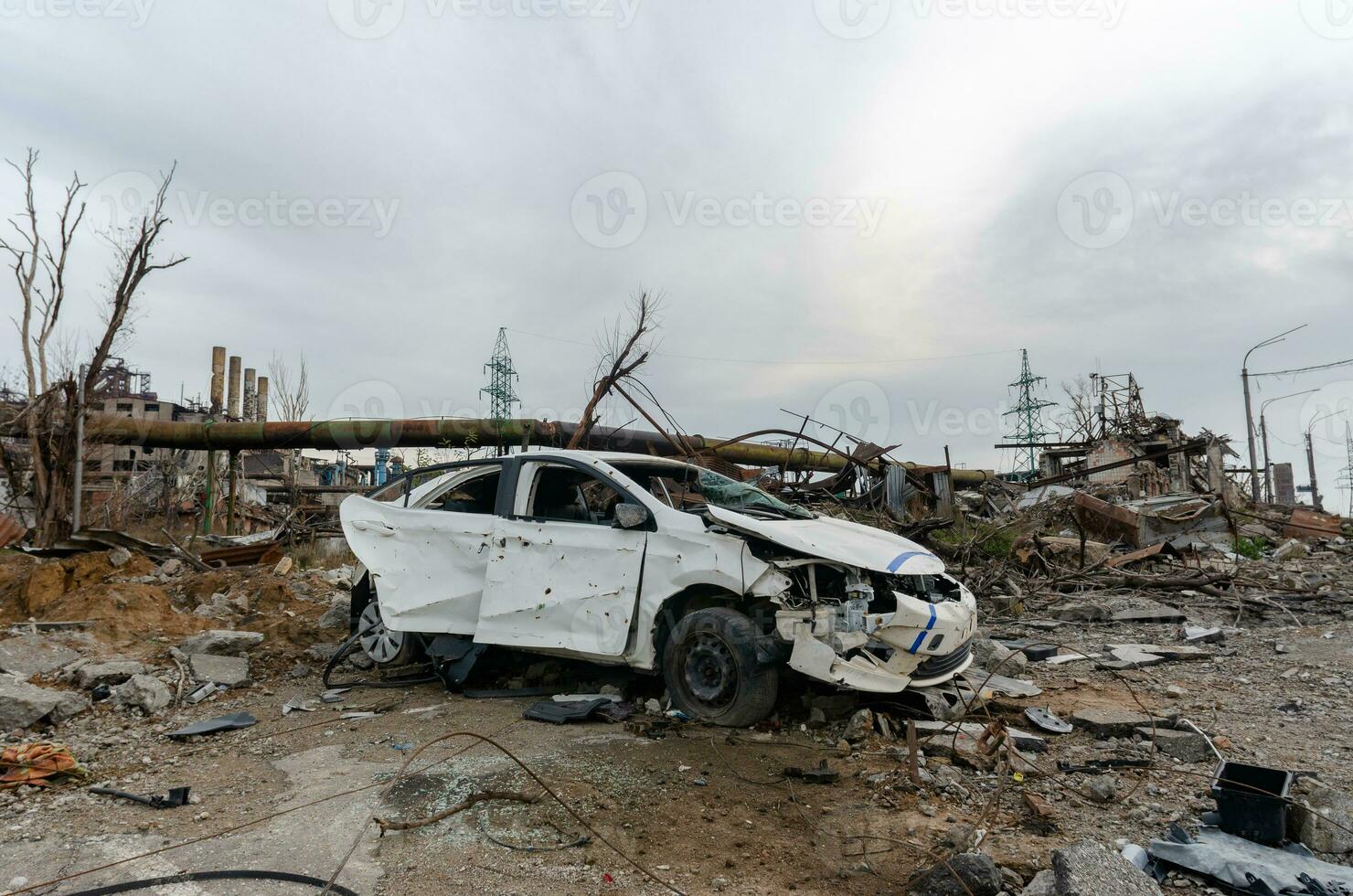 burnt cars and destroyed buildings of the workshop of the Azovstal plant in Mariupol photo
