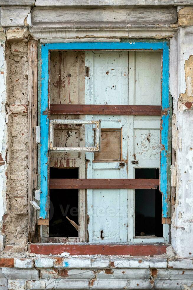 empty windows of a damaged house in Ukraine photo