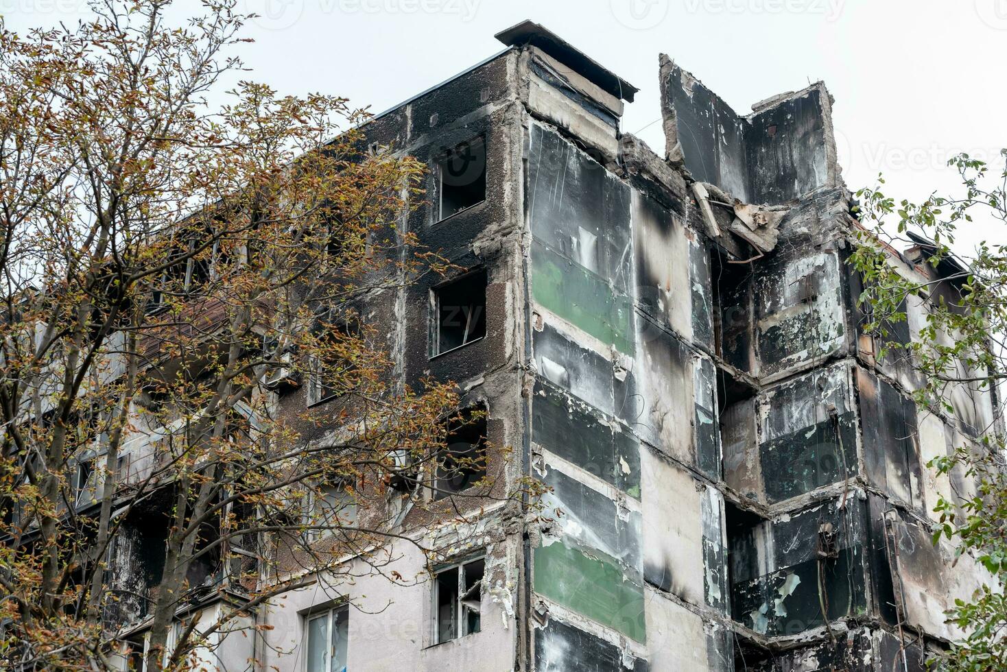 destroyed and burned houses in the city during the war in Ukraine photo