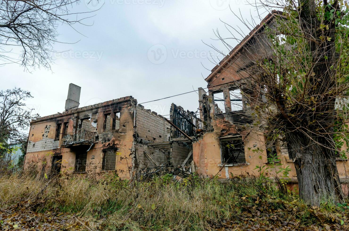 destroyed and burned houses in the city during the war in Ukraine photo