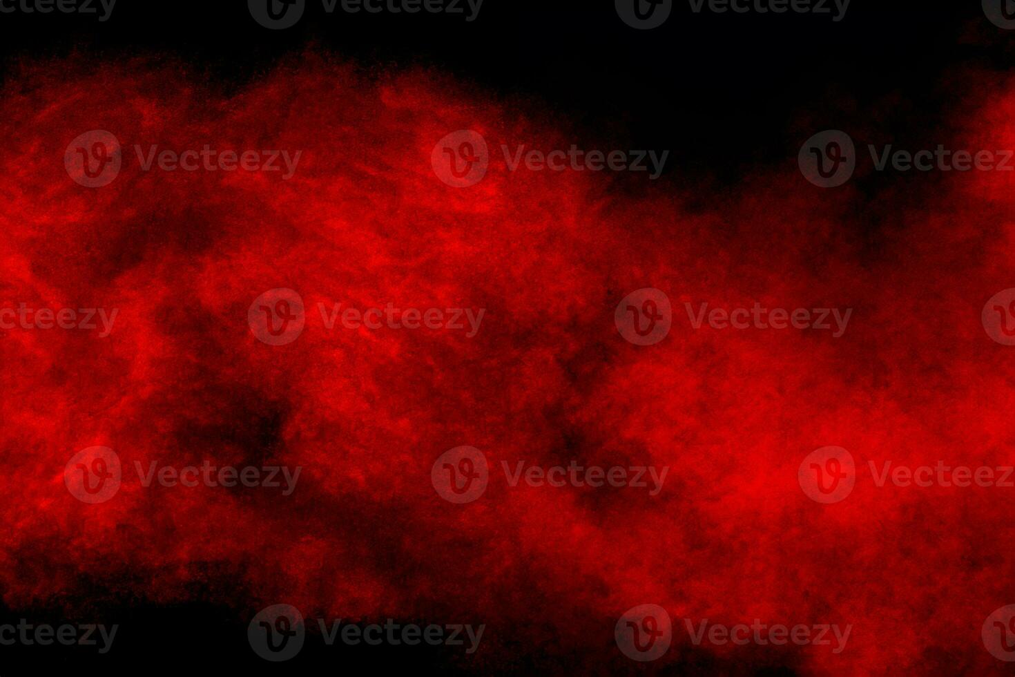 Red powder explosion cloud on black background. photo