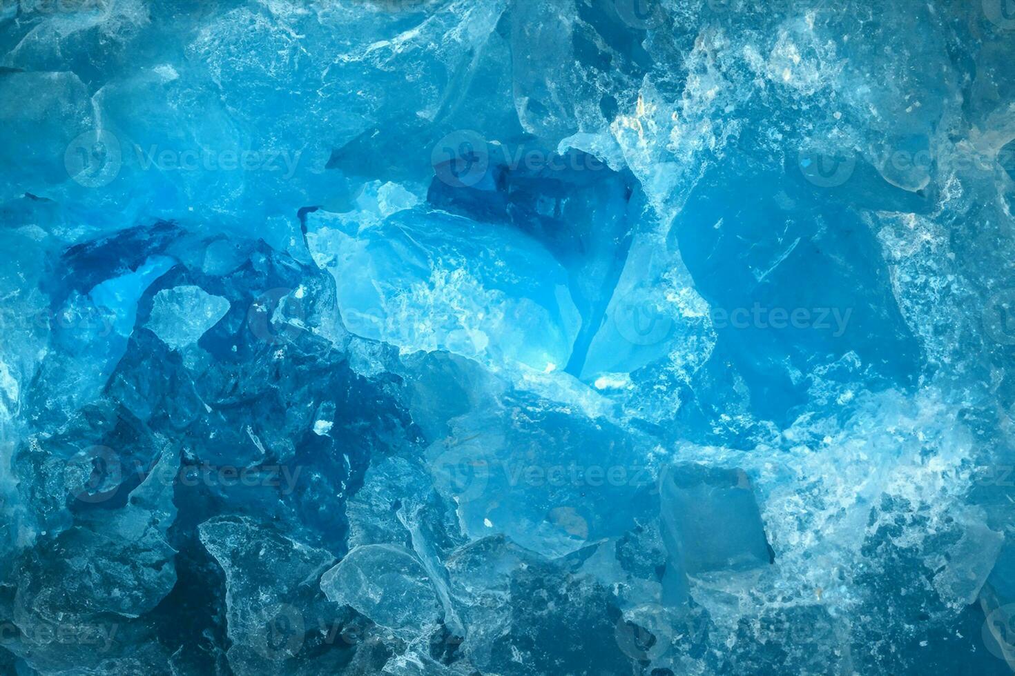 Pieces of crushed blue ice glass cracks background texture. close-up frozen water photo