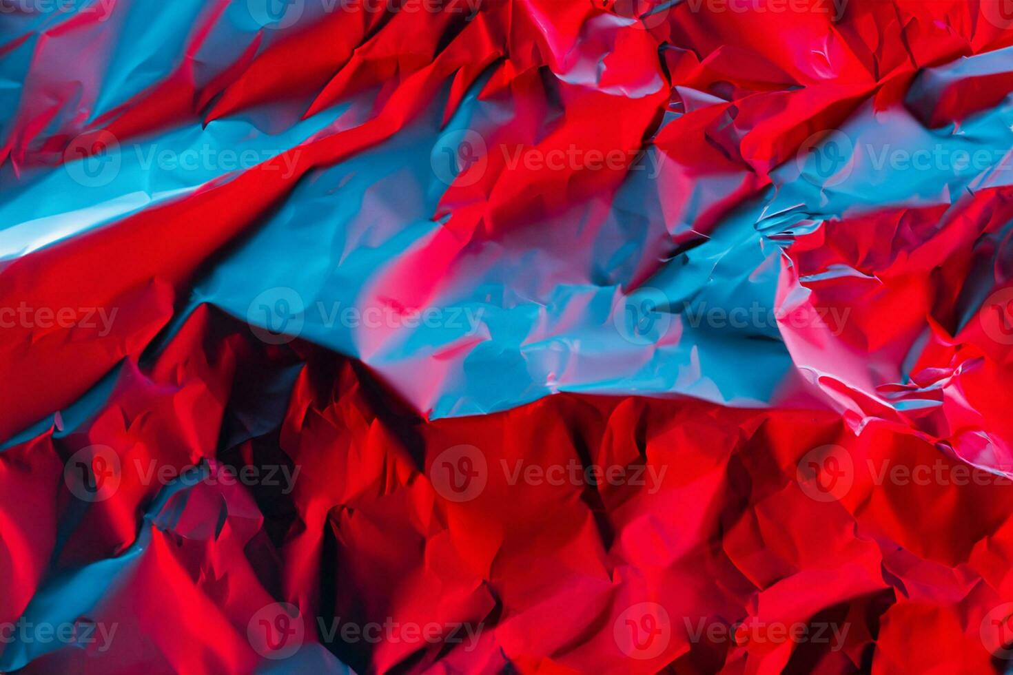Crushed paper background in vibrant bold gradient holographic neon colors. Fire background imitation. Flat lay. Top view. photo