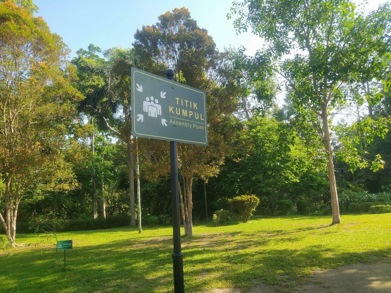 a signpost indicating the gathering point on the grass photo