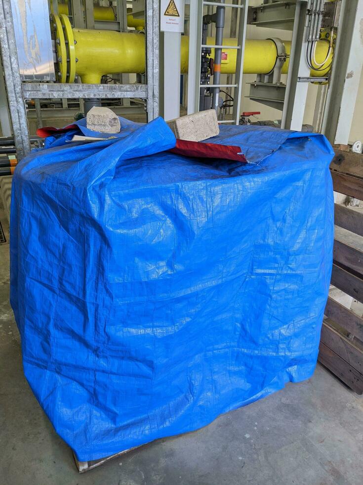 Blue drum and pail for chemical storage on power plant process. photo