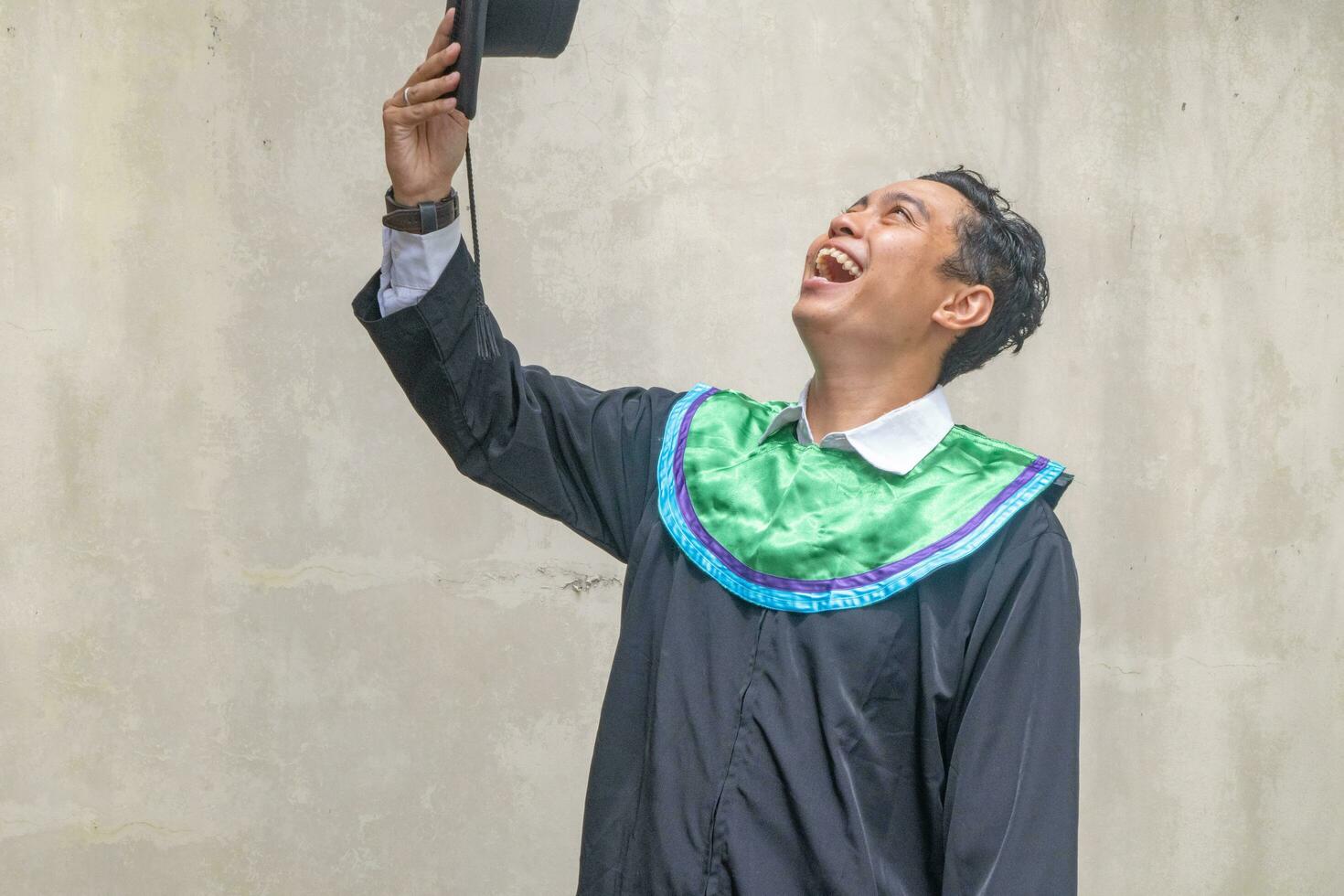 Young Indonesian guys celebration and cheers when graduation moment. photo