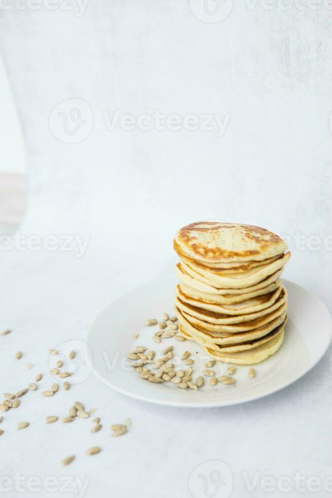 Homemade pancakes on kefir on a white plate. Cooking at home, home-cooked food. Space for text. photo