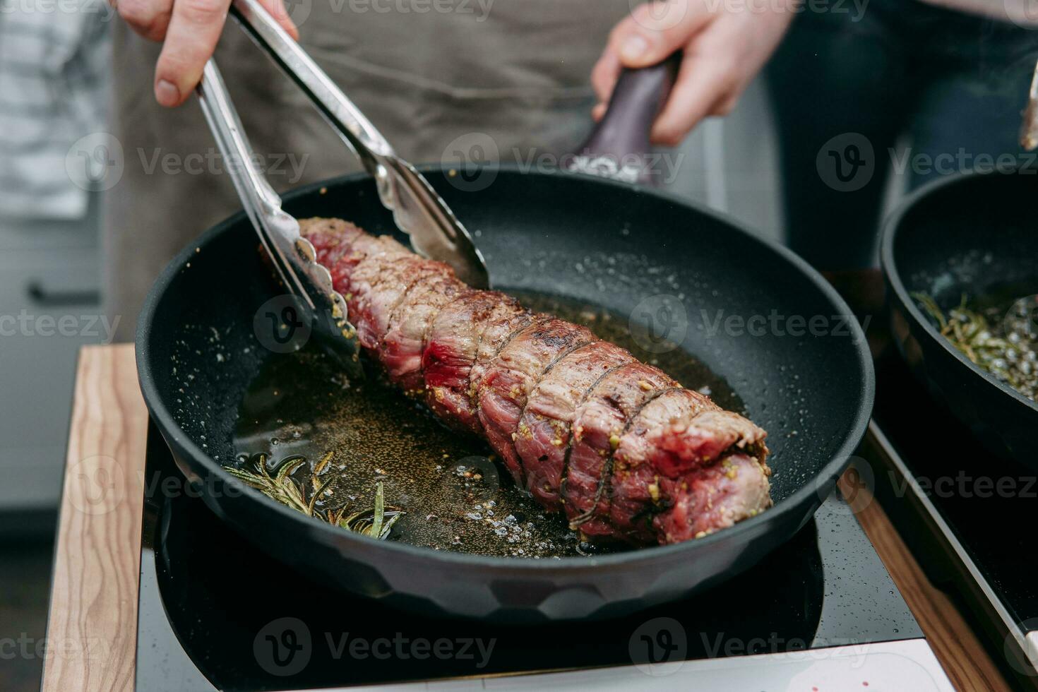Cooking meat rolls in a frying pan in the cooking class. Beef roll with spices. Cooking process, close-up. photo