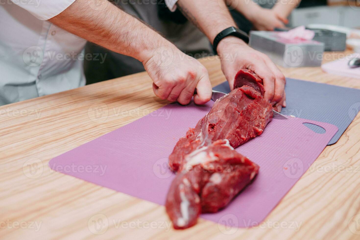Preparation of raw meat roll. Cooking steaks and meat rolls in the cooking class. Sliced meat on a plate. photo