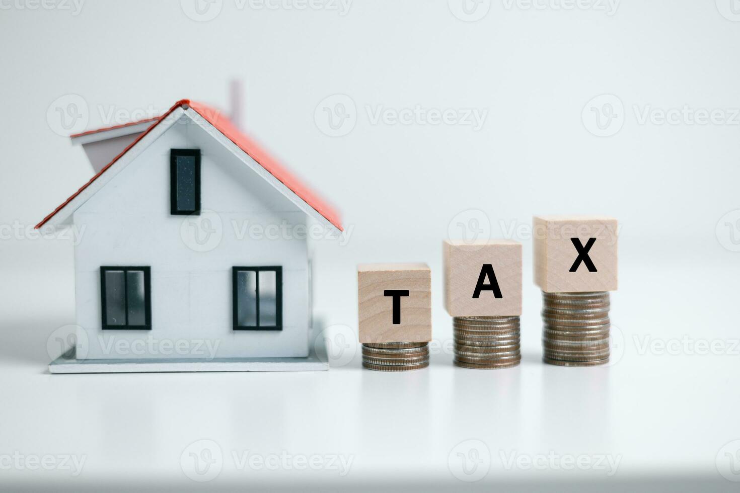 Concept of paying state property tax. Property Tax Wooden Blocks With A Miniature House. house model, mortgage loading real estate property with loan money bank concept.Home sales and home insurance photo