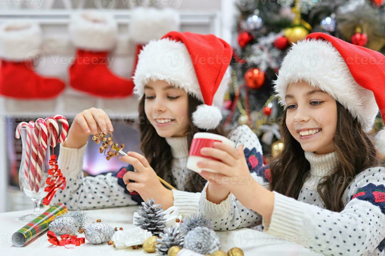 Portrait of girls in Santa hat preparing for Christmas photo