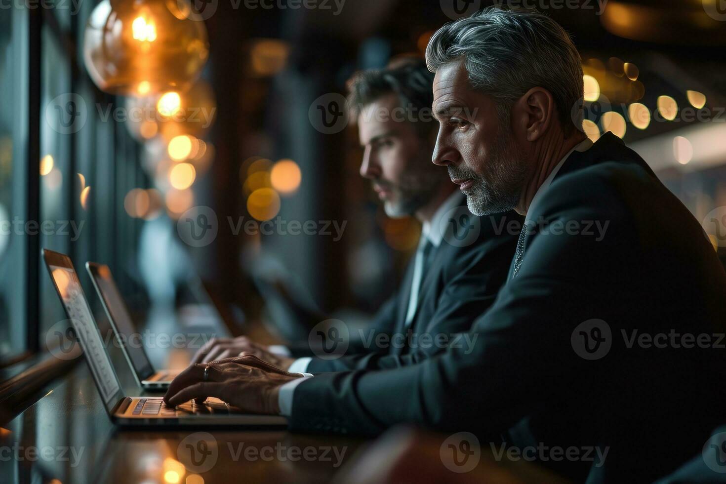 AI generated Professionals in formal attire reviewing data on laptops, business meeting image photo