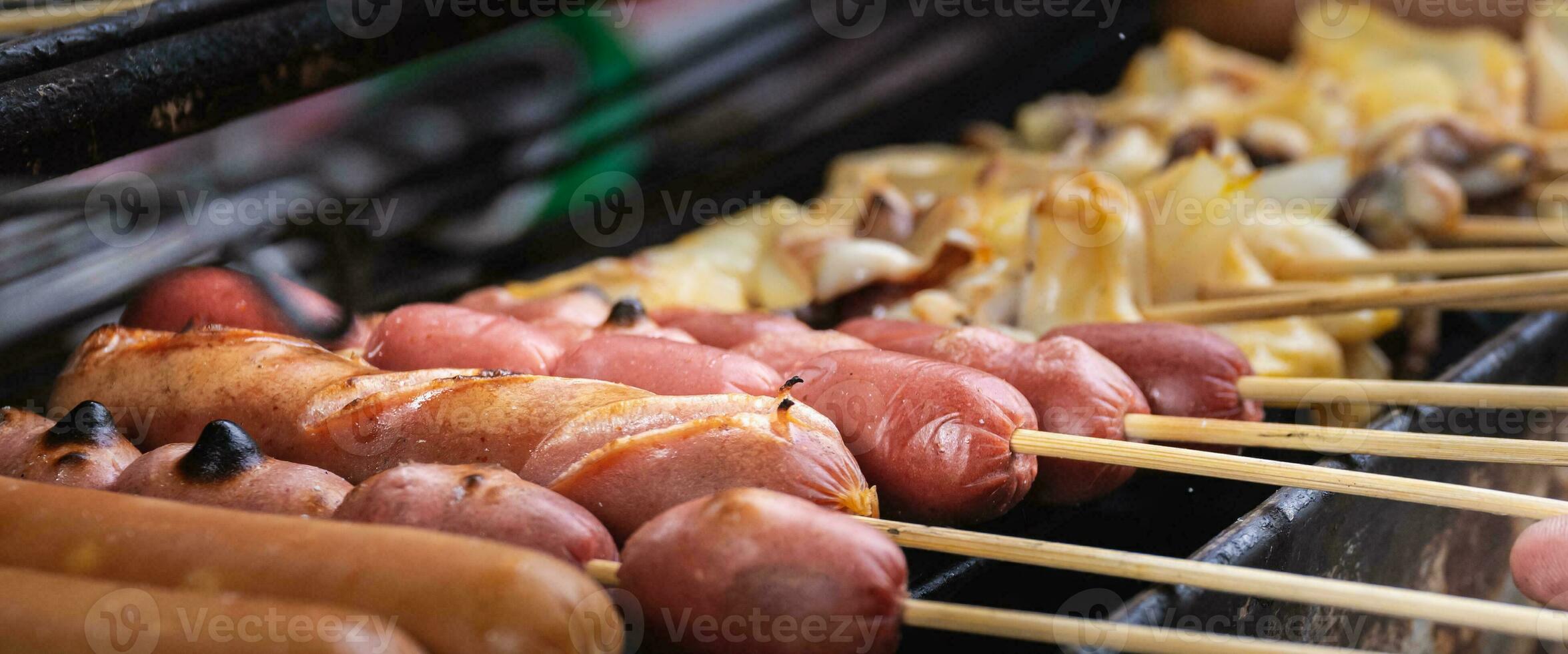 Sausages and Squid are Grilling on the open fire outside, Grilling Food, Charcoal grilling. photo