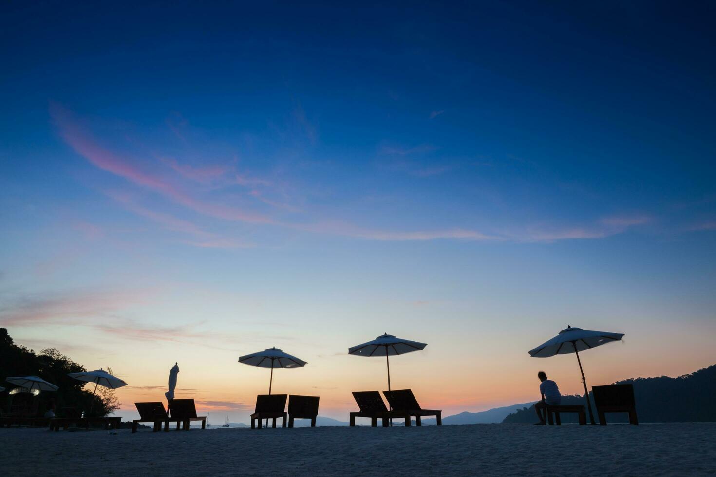 umbrella on beach under vivid colorful of sky photo