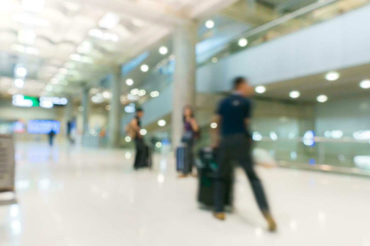 Blur of passenger walking  at airport building photo