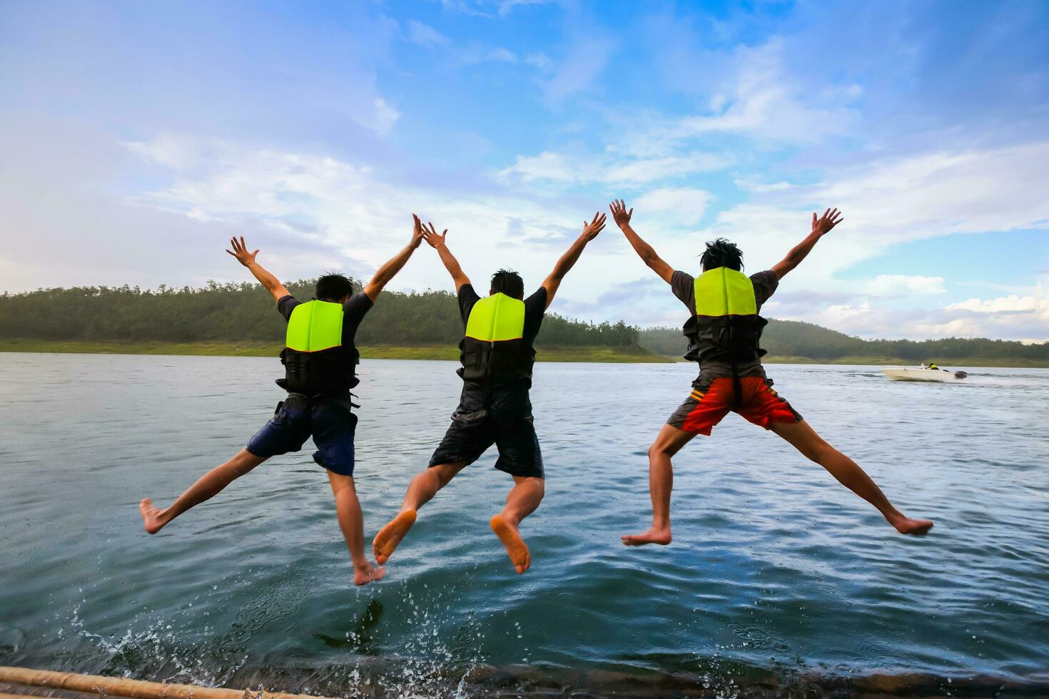 People is jumping to water in dam photo