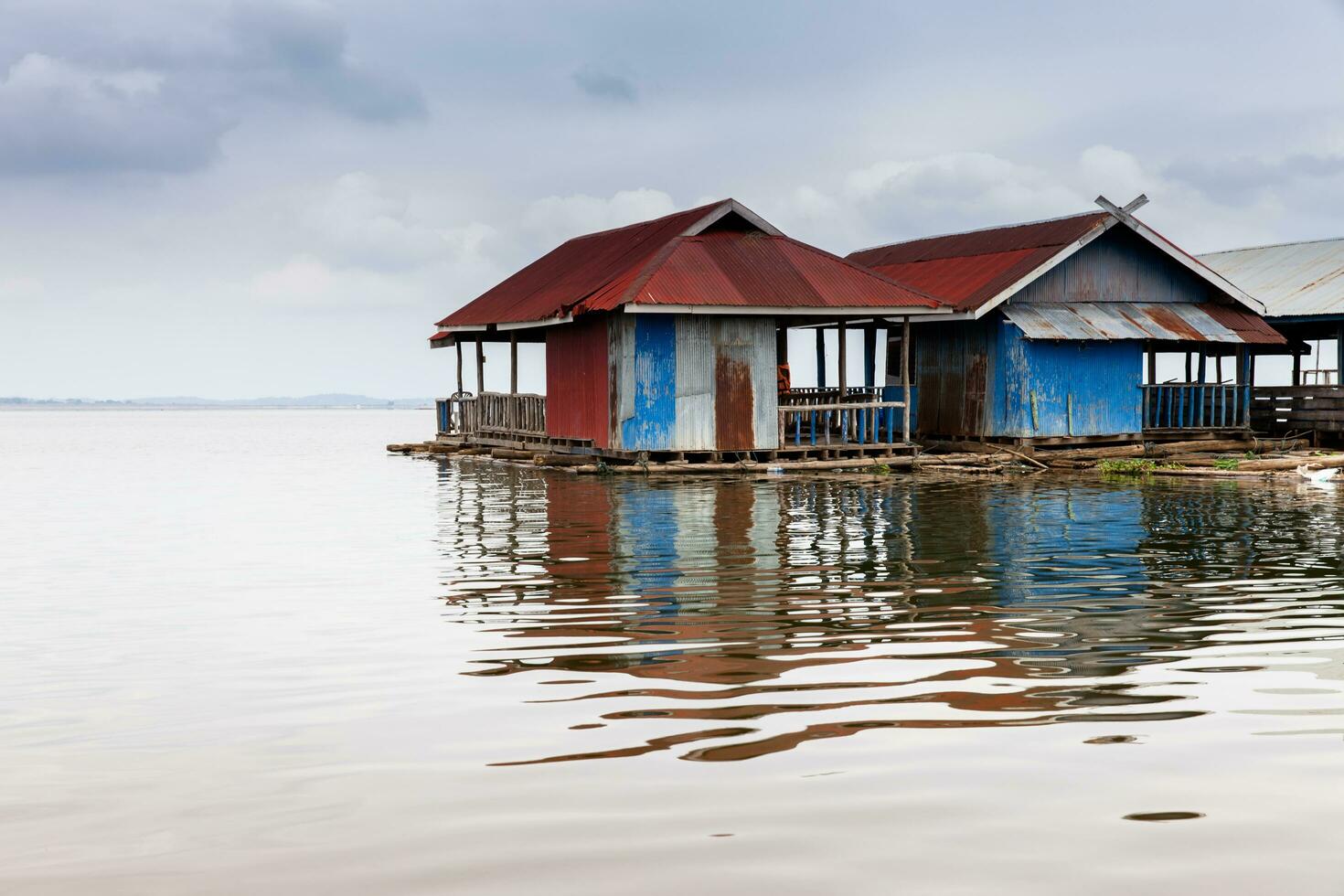 Floating wooden house village in dam photo
