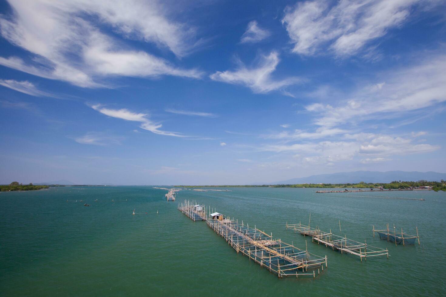 Floating fish farm in sea under clear sky photo