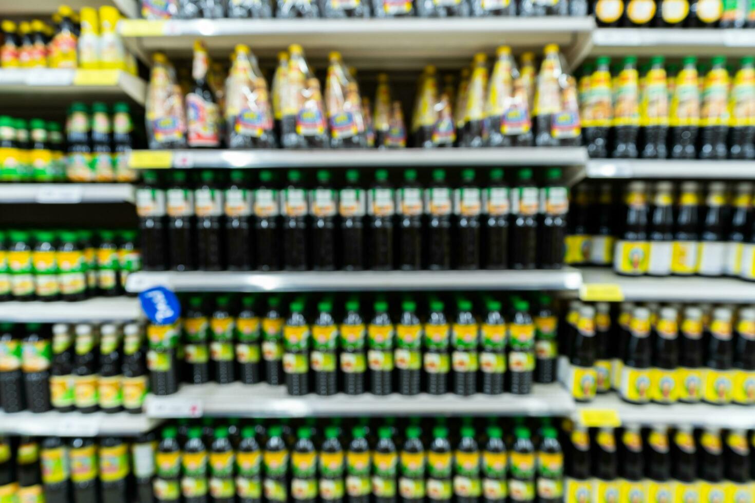 Blur image of shelf with consumer product shop in supermarket photo