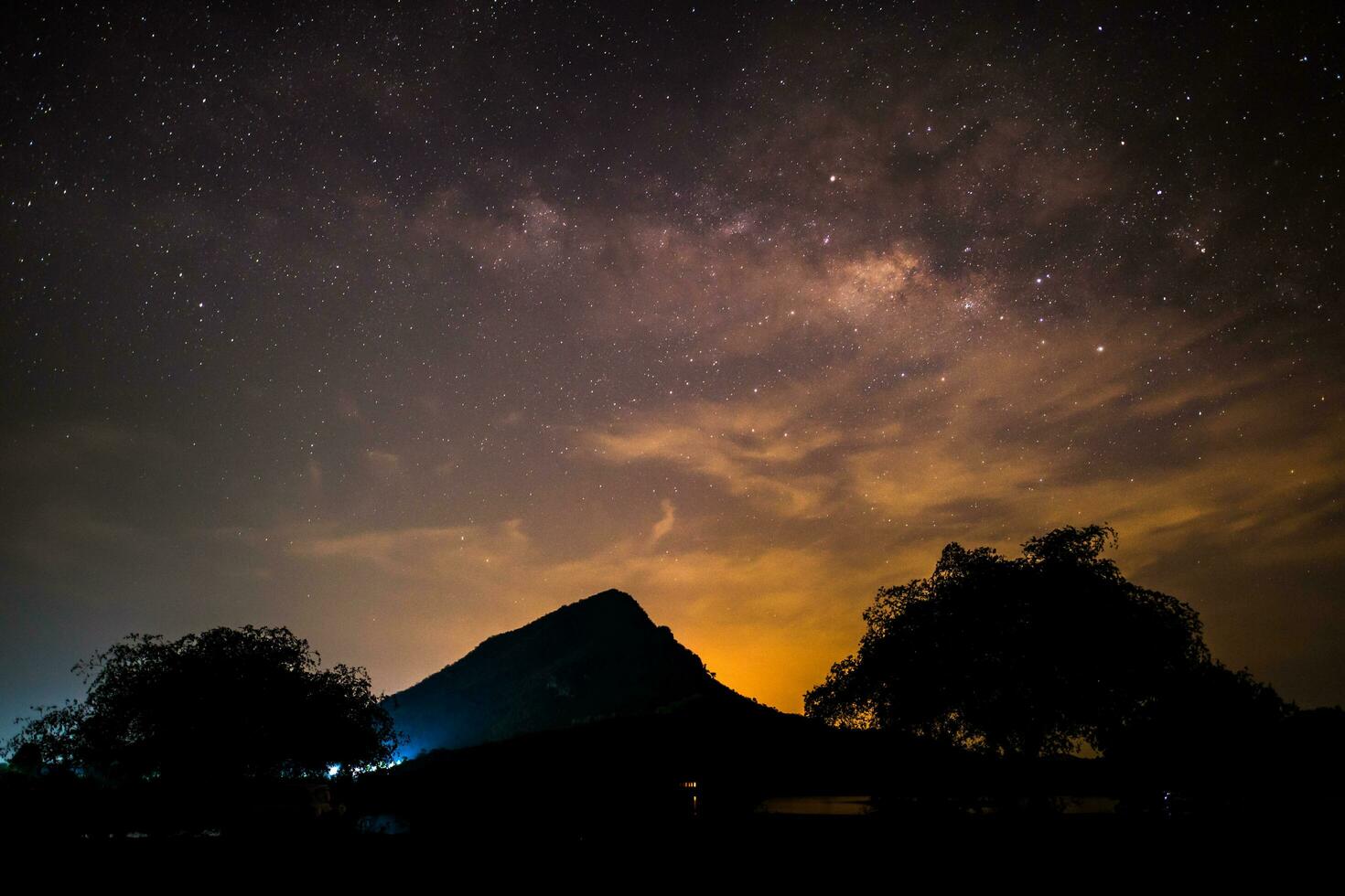 Milky way at nigh sky above mountain photo