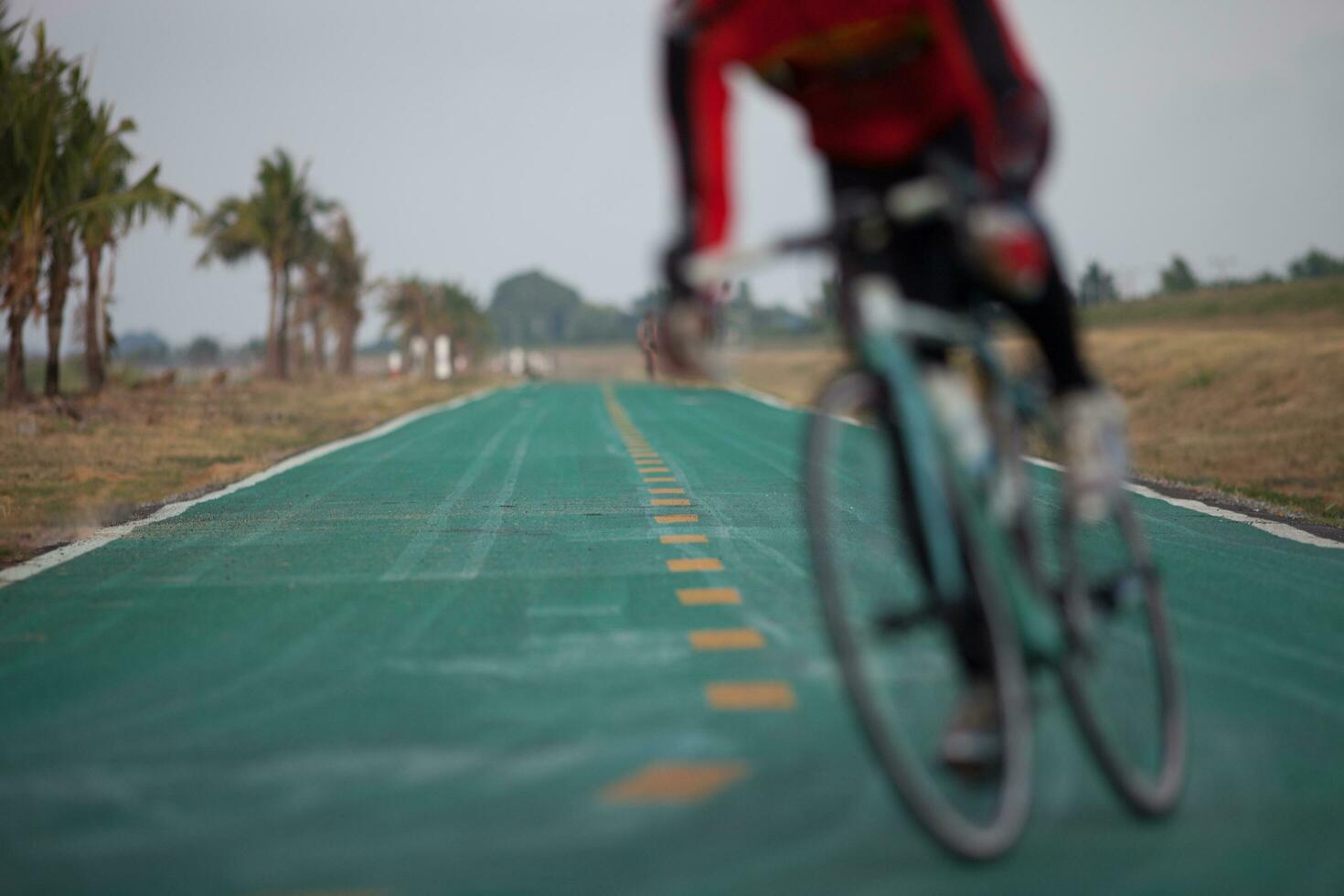 riding bicycling is on lanes againts sky photo