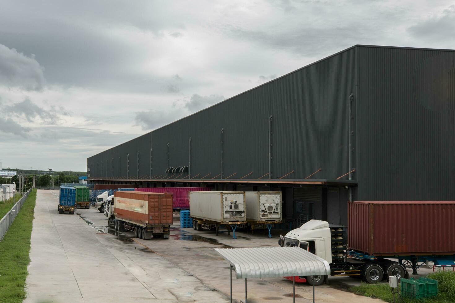 Truck is carrying container parking in front warehouse photo