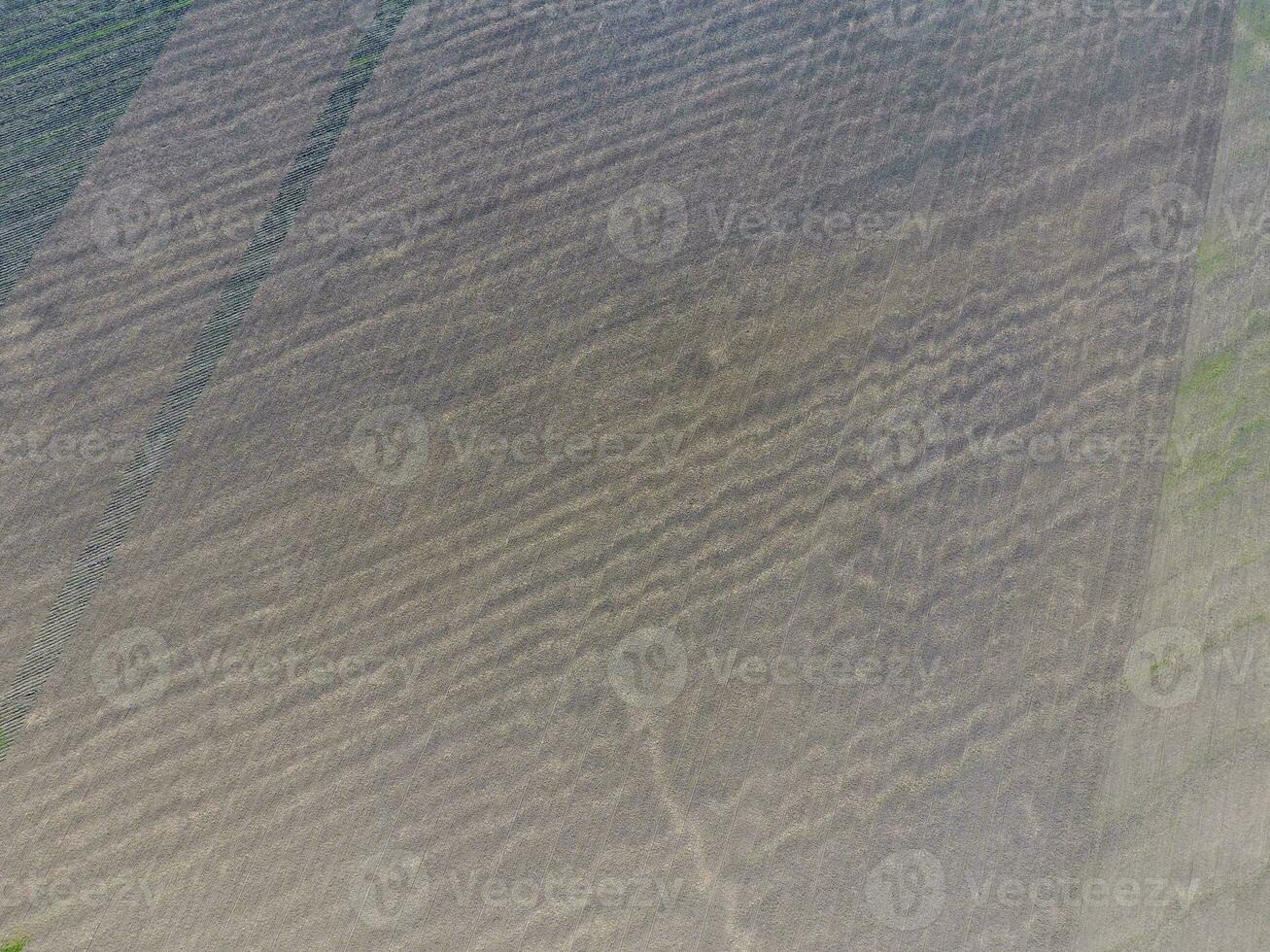 Top view of a plowed field. Background texture of the surface of the plowed field. Shooting with quadrocopters photo