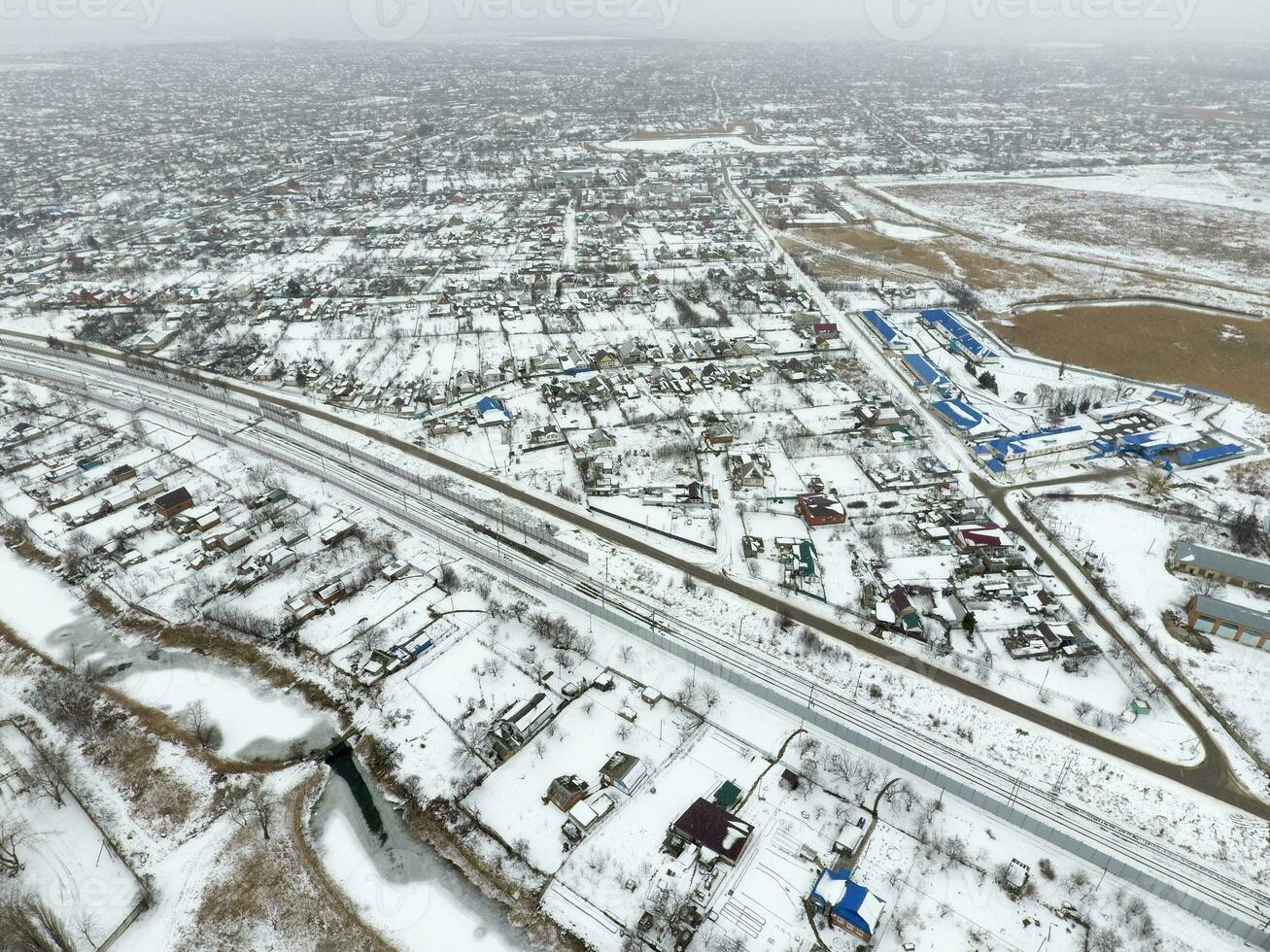 Winter view from the bird's eye view of the village. The streets are covered with snow photo