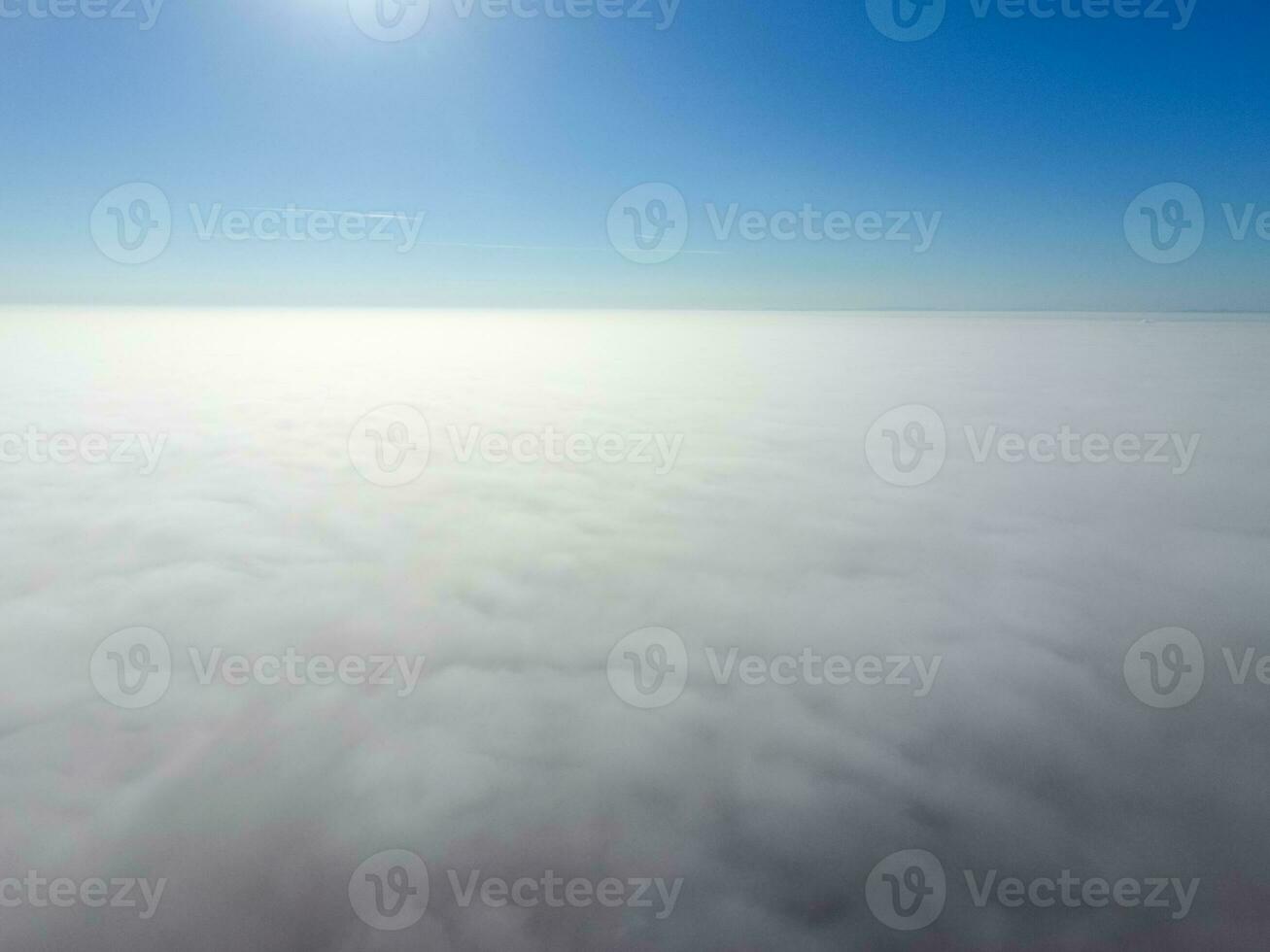 In the skies above the fog. Sunrise over the fog. Clouds near the ground photo