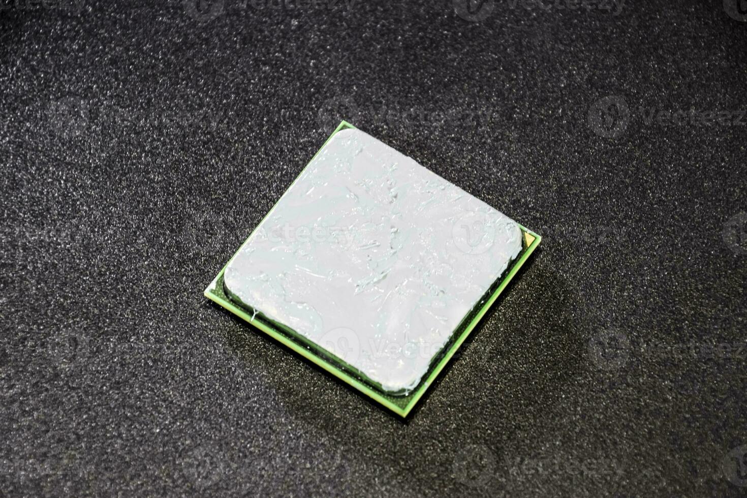 The processor of the computer with the thermal paste applied on it. Details of the computer's system unit. photo