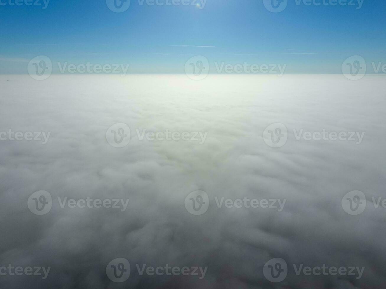 In the skies above the fog. Sunrise over the fog. Clouds near the ground photo