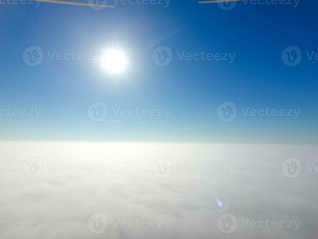 In the skies above the fog. Sunrise over the fog. Clouds near the ground photo