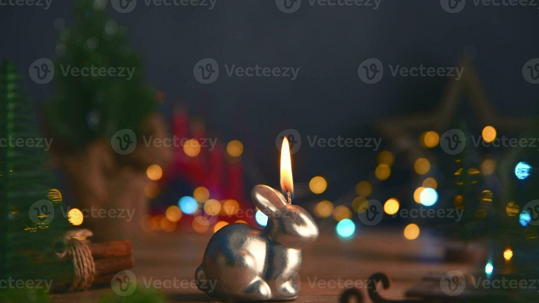 a candle burns in the form of a rabbit, a symbol of 2023 photo