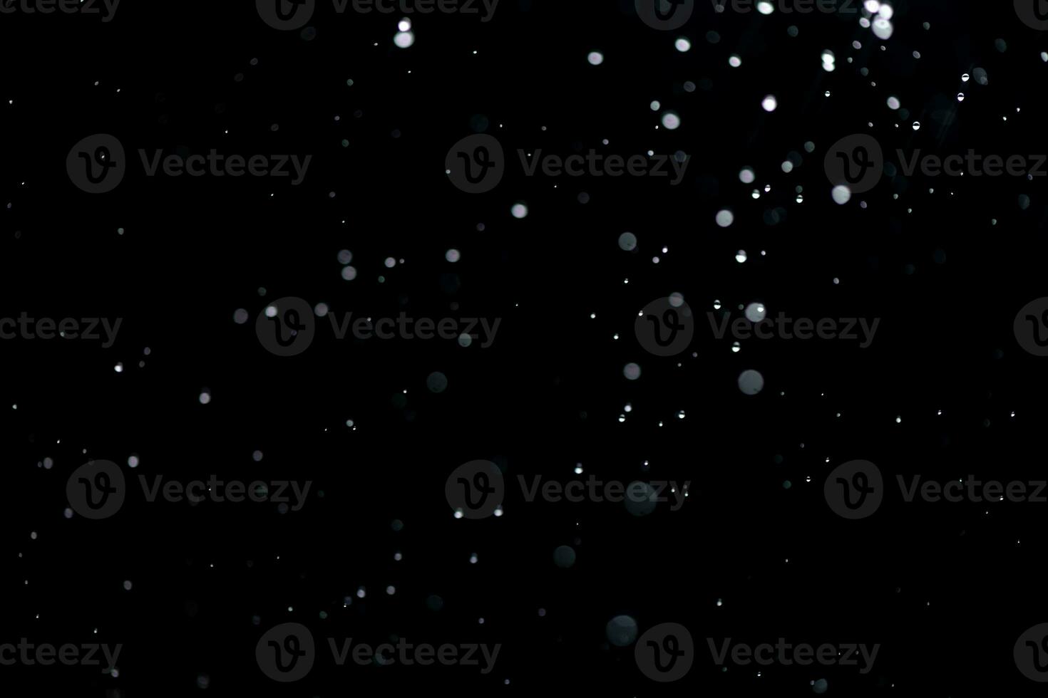 small drops of rain, snow on a black background. wind. Natural background photo