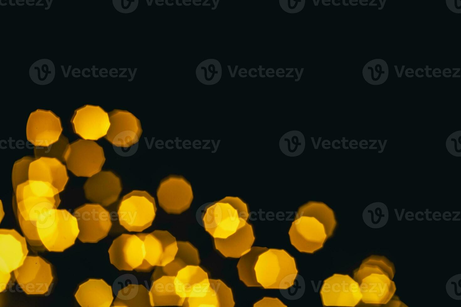 background, texture. Yellow round bokeh stars on black background photo