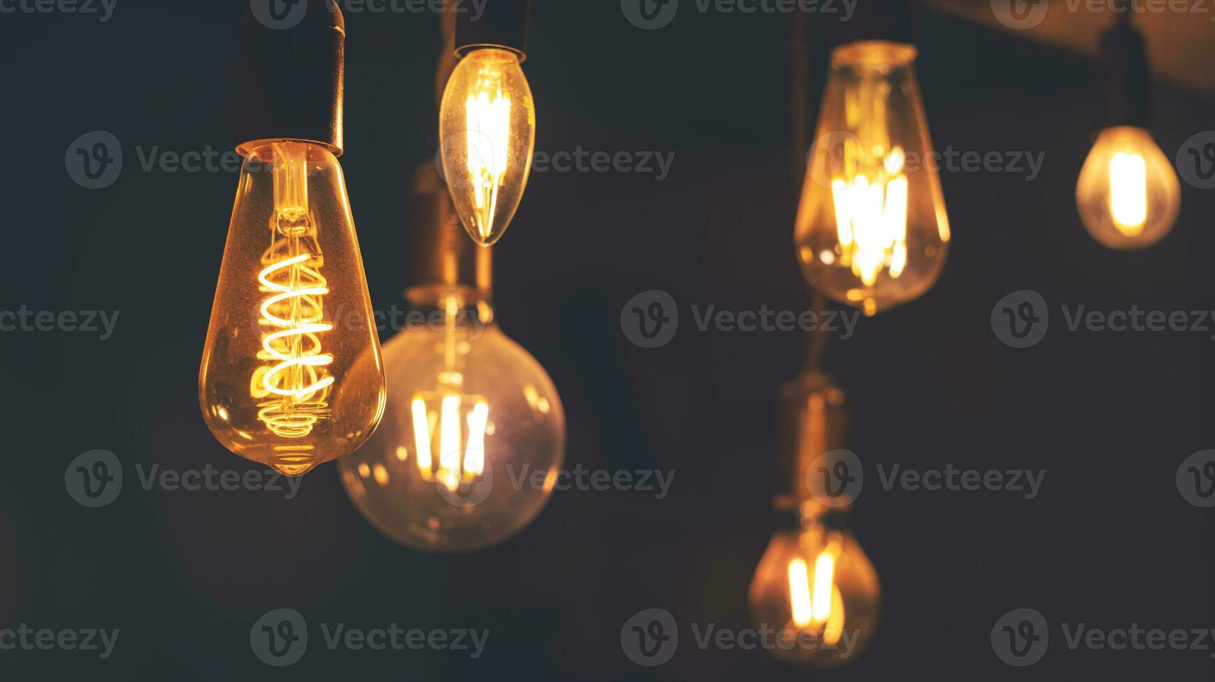 Retro light bulbs hanging on a dark background. Electricity, Vintage photo