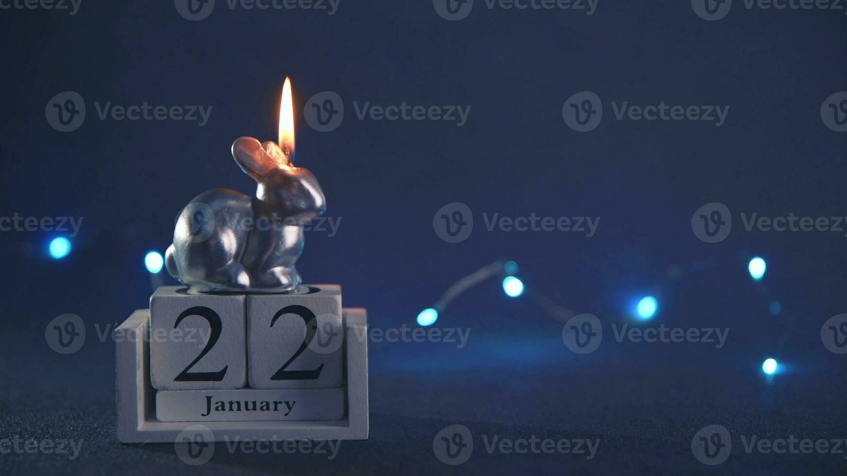 a candle burns in the form of a rabbit, a symbol of 2023 photo
