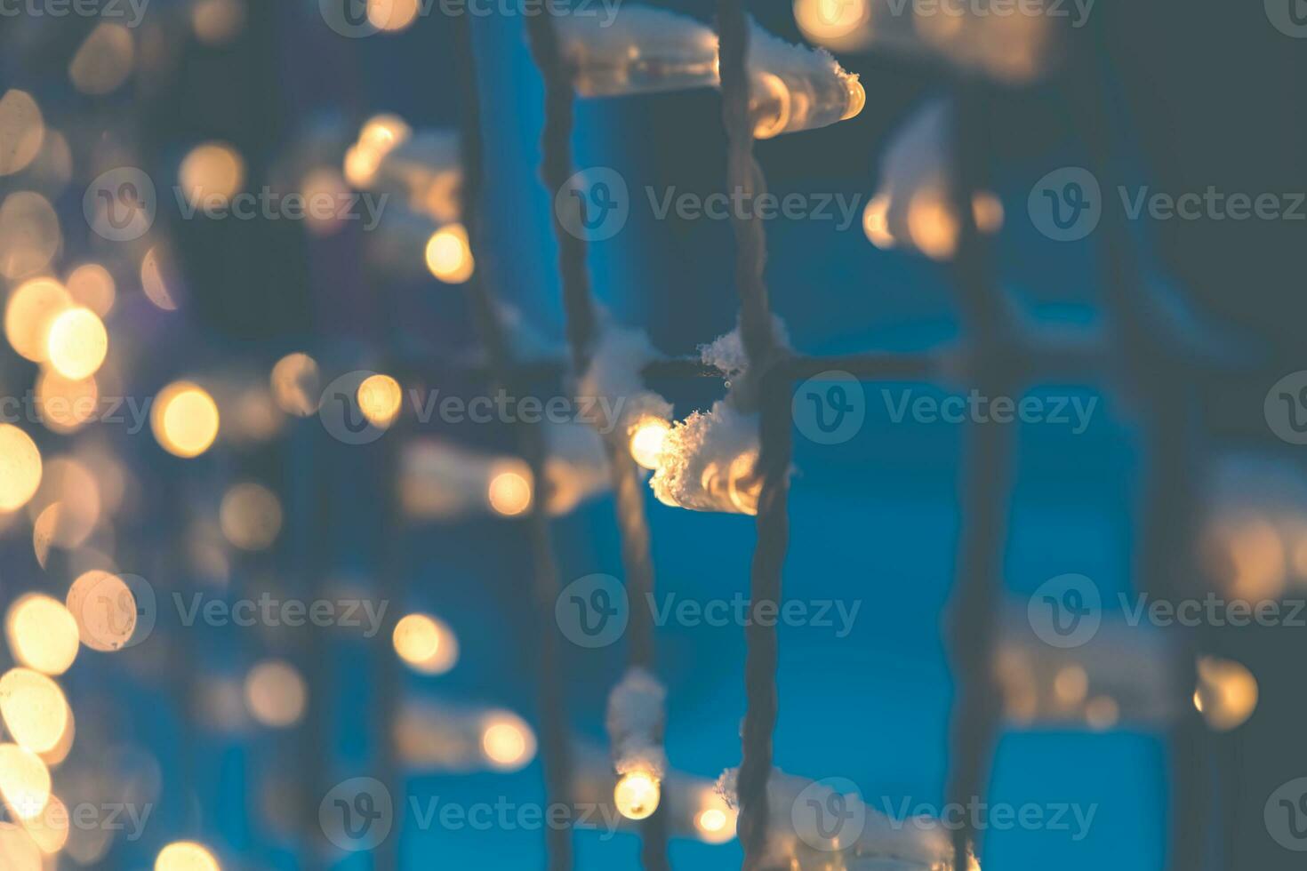 Navy blue color blurred background with shiny gold garland lights photo