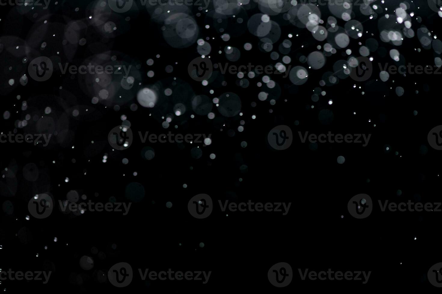 small drops of rain, snow on a black background. wind. Natural background photo