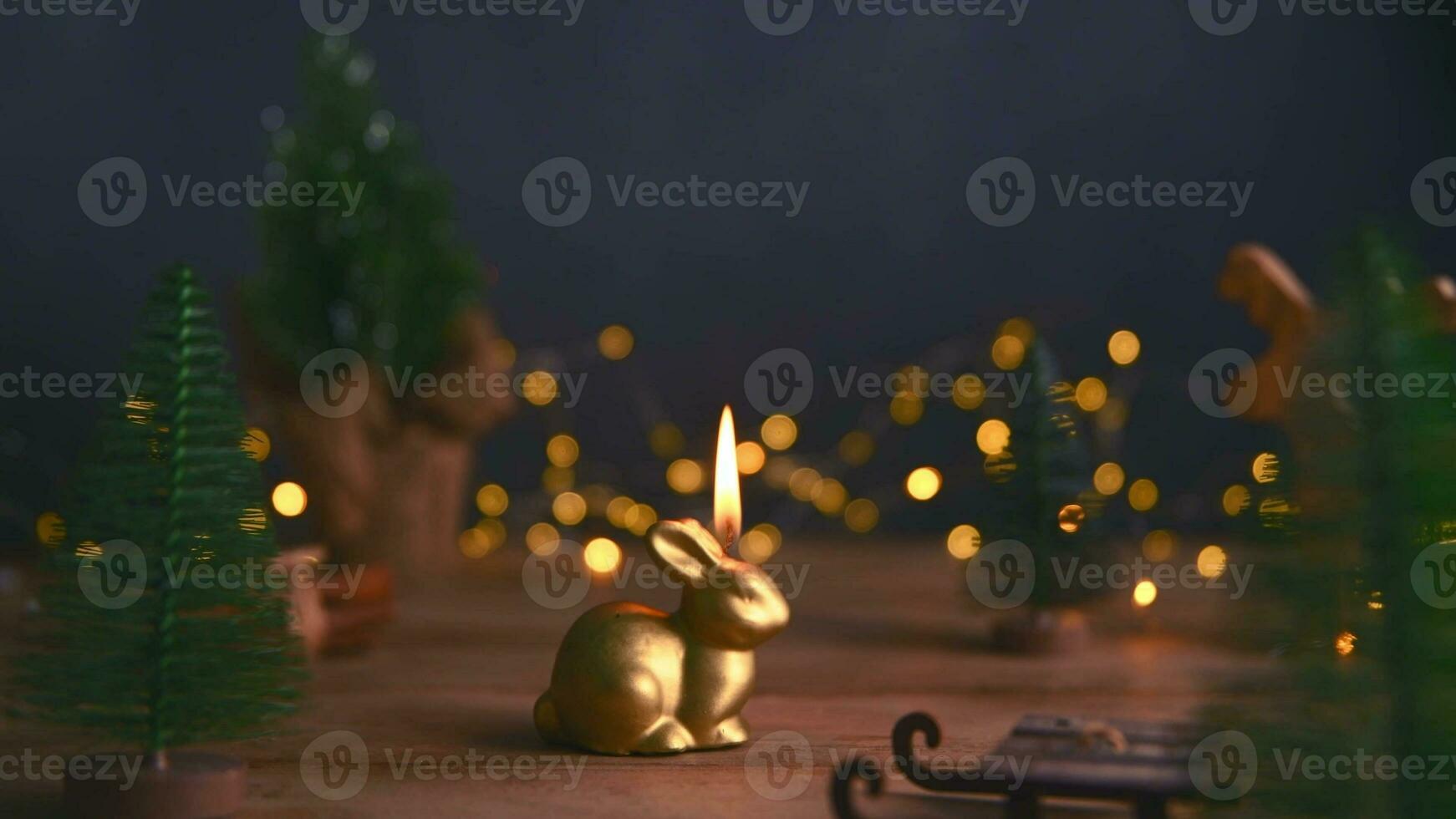 a candle burns in the form of a rabbit, a symbol of 2023 photo