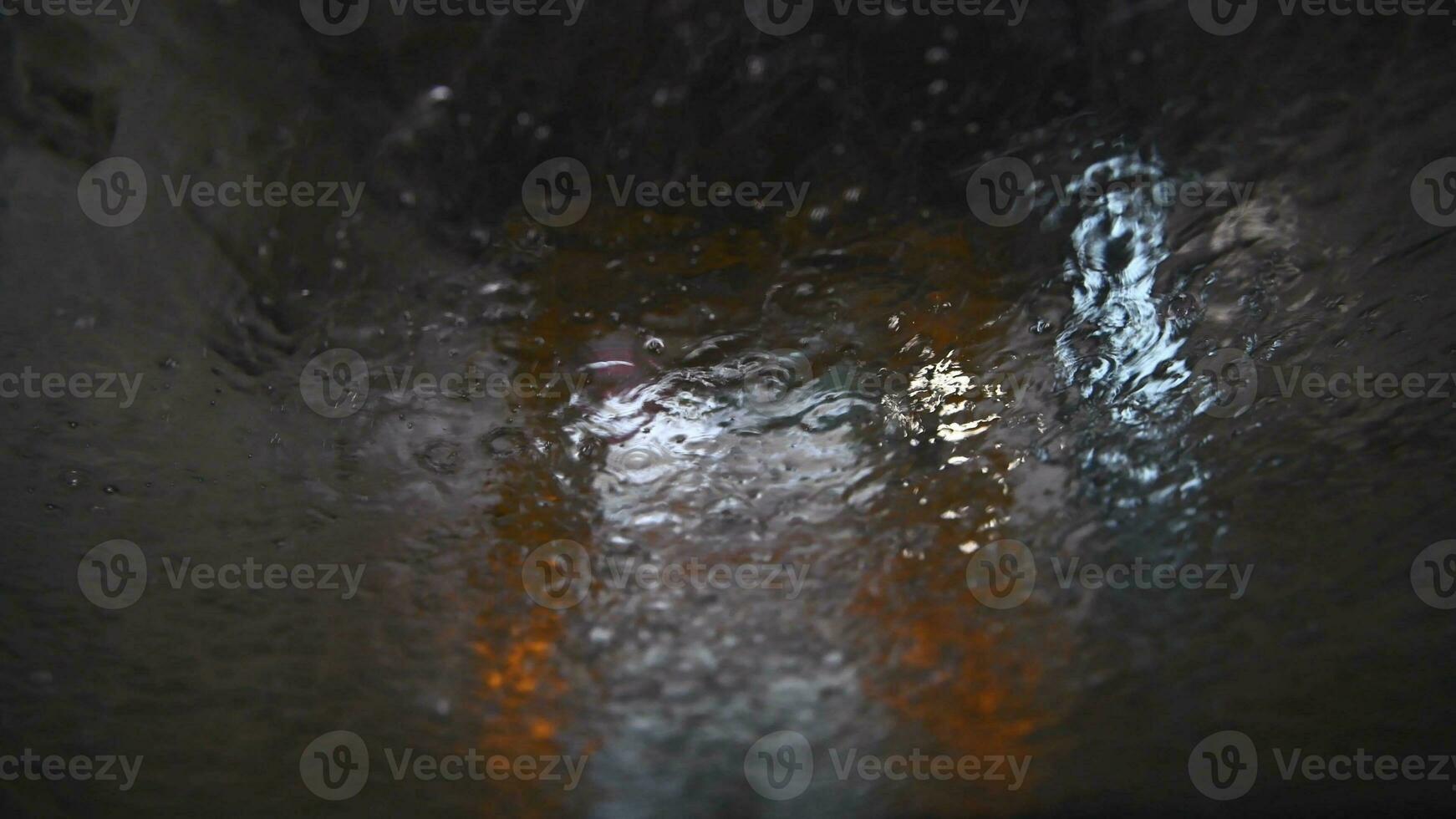 View from the car in the automatic car wash. Water pouring down the windshield photo