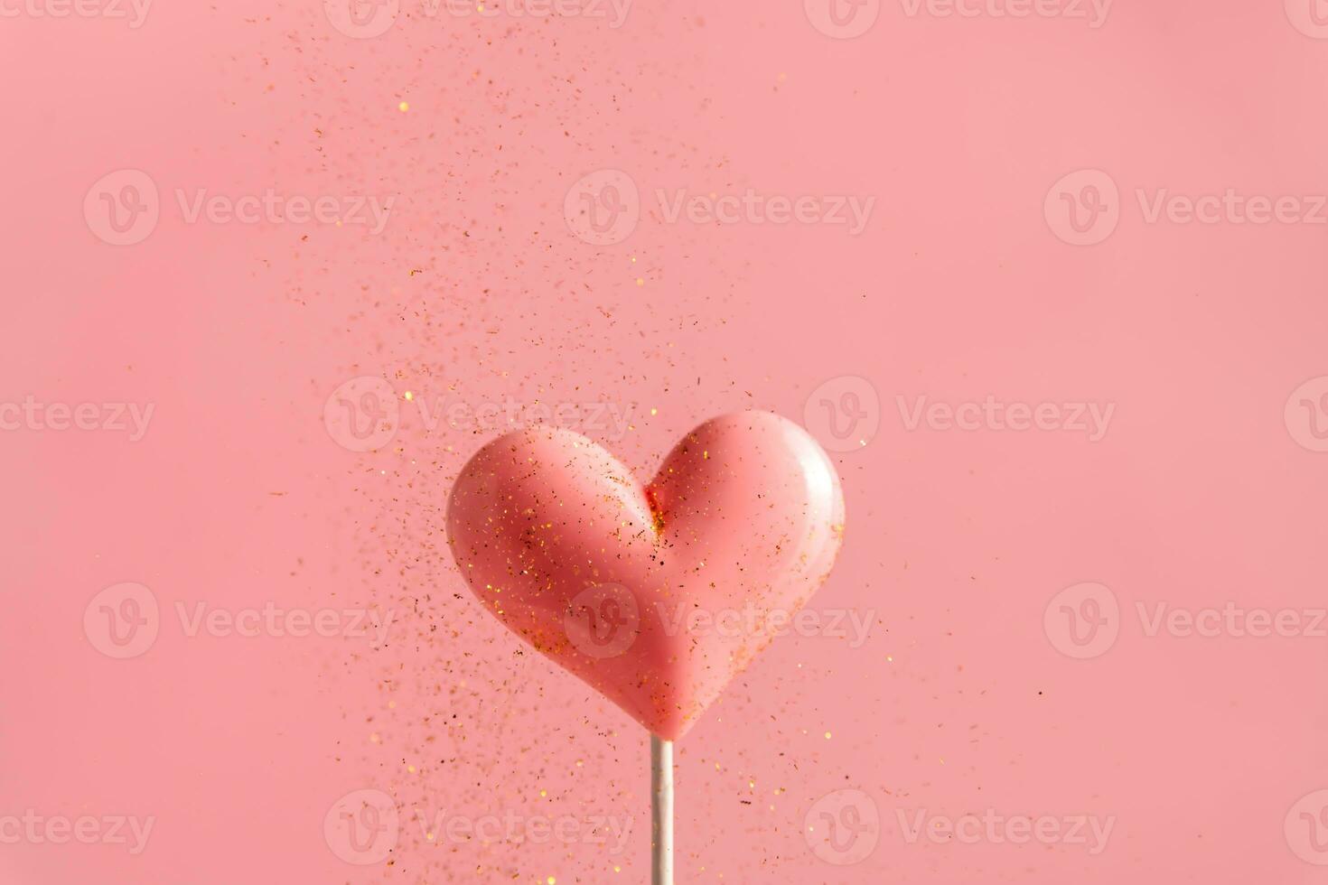 Pink Valentine's day heart shape lollipop candy on empty pastel paper background. Love Concept photo