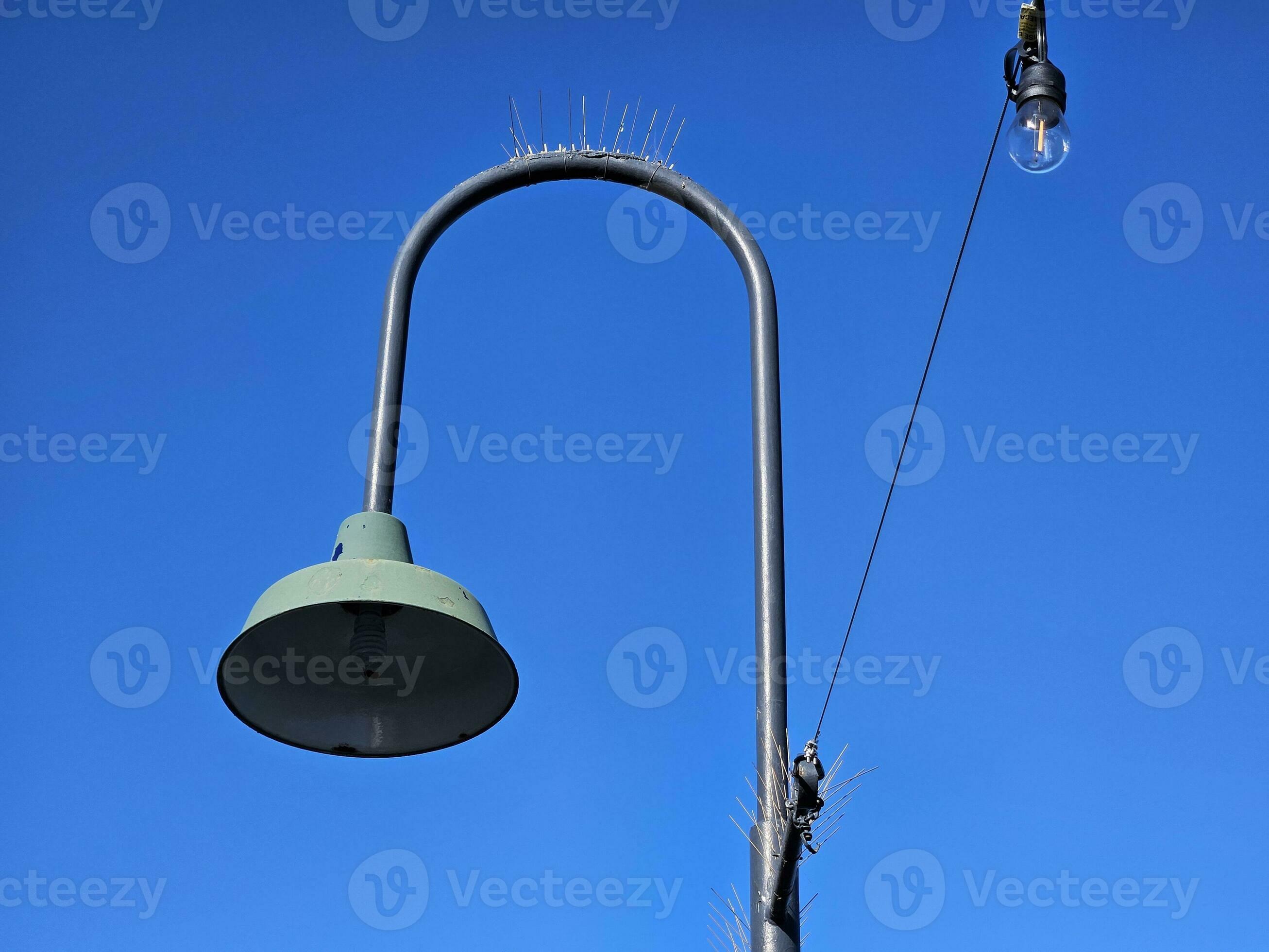 Light bulb in a pure blue sky background without clouds in San