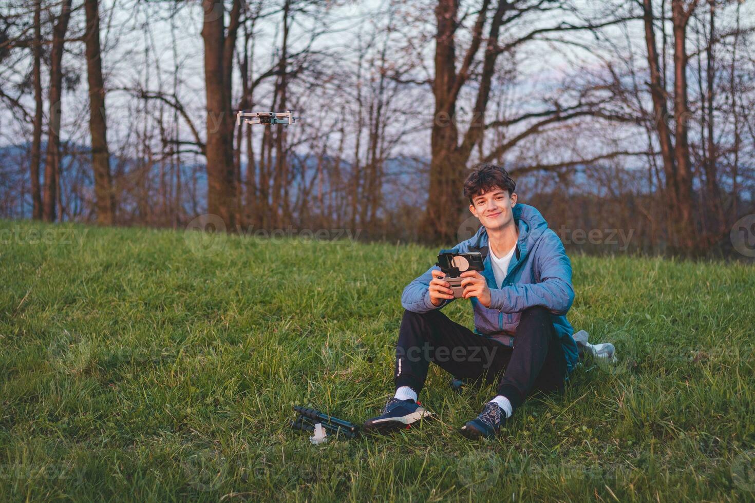 Young cinematographer shoots parts of a film using a technological product called a drone. Recording the sunset from an aerial view photo