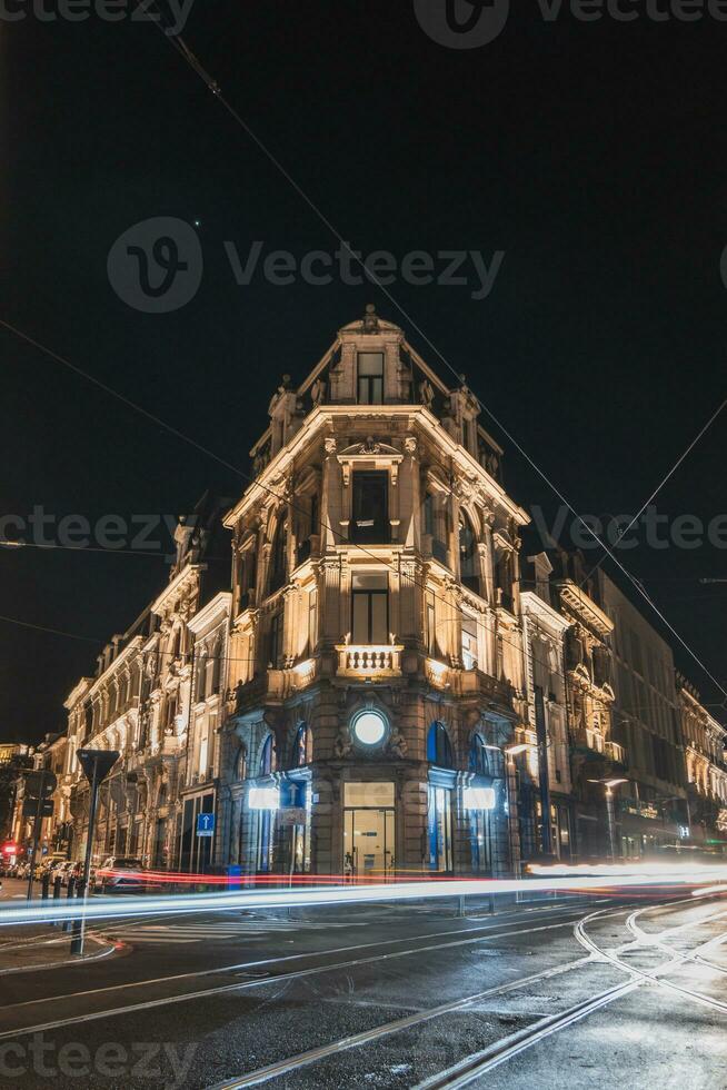 Historical and medieval architecture of Ghent during a dark night. Building illuminated by coloured lights on Lammerstraat. Flanders region, Belgium photo