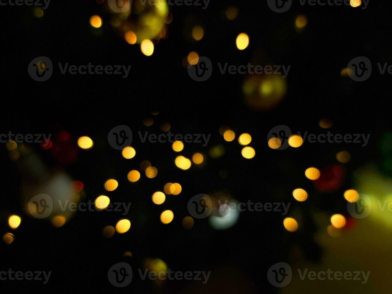 christmas round abstract bokeh blur light orange and white glowing flare pattern black background photo
