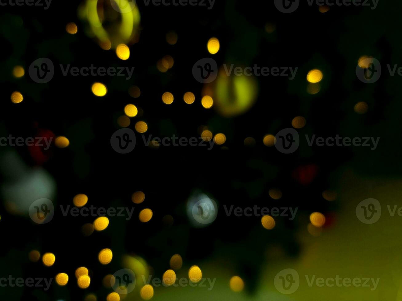 abstract bokeh blur light christmas tree multi color orange and white glowing flare pattern black background photo