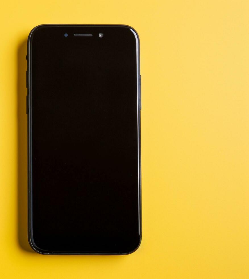 AI generated Modern smart phone on yellow background, close up generated by AI photo