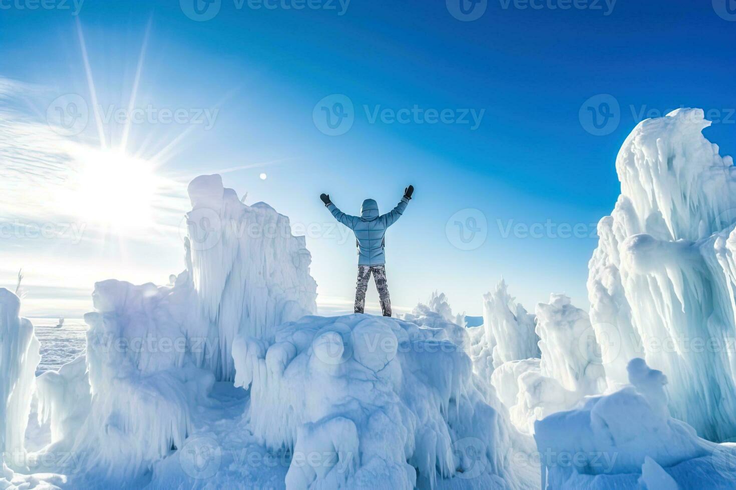 AI generated Rear view of a young climber joyfully raises his hands on top of an icy mountain photo