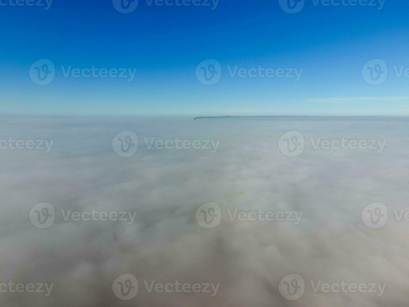 In the skies above the fog. Sunrise over the fog. Clouds near the ground photo